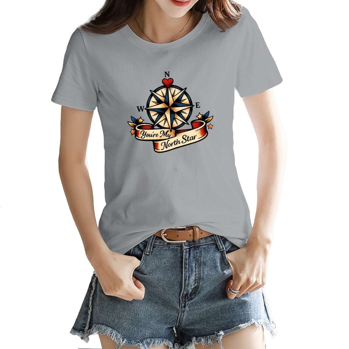 Person wearing a gray t-shirt with a compass design and text.