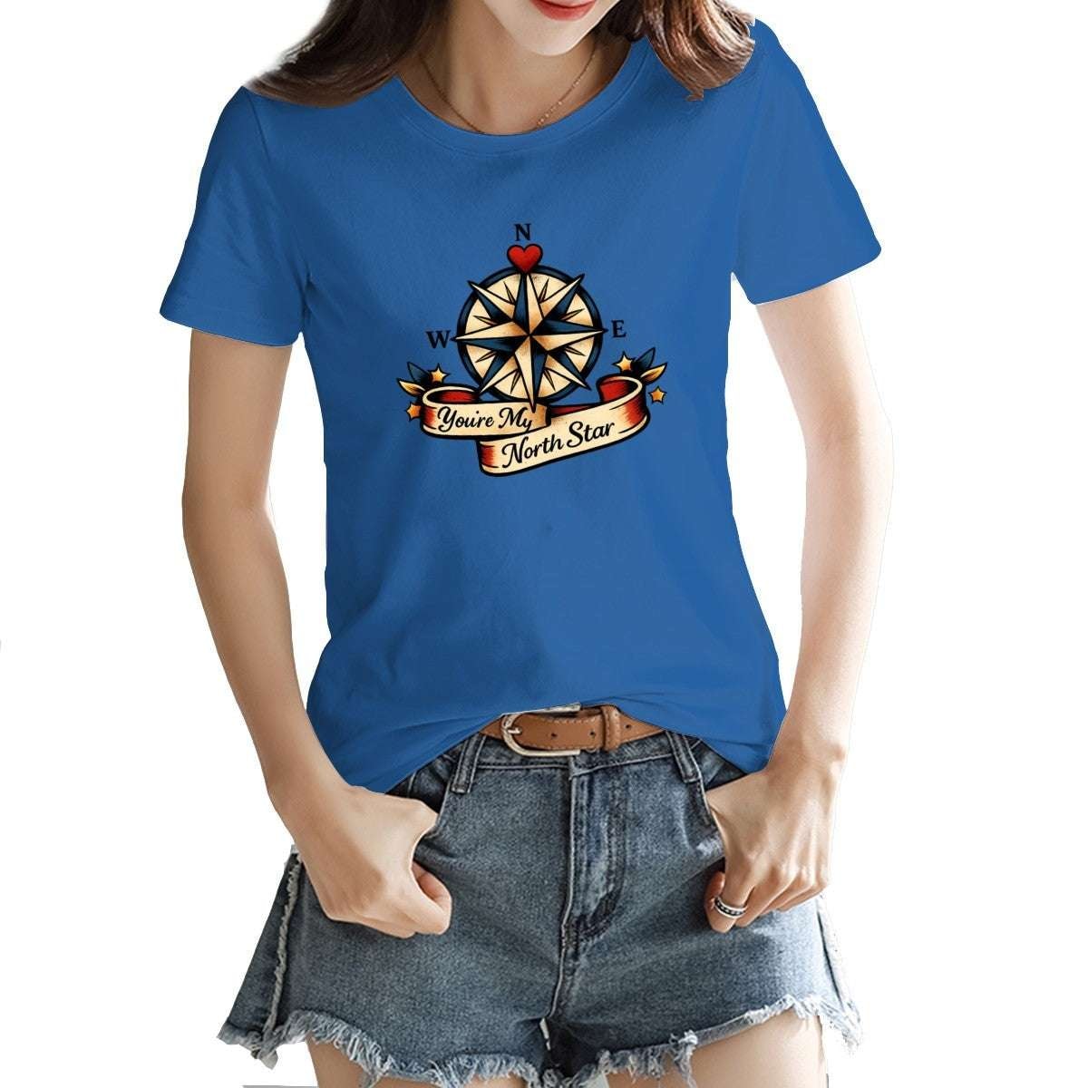 Person wearing a blue t-shirt with a compass design and text.