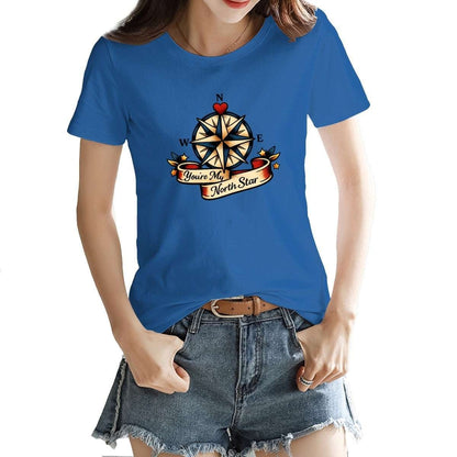 Person wearing a blue t-shirt with a compass design and text.