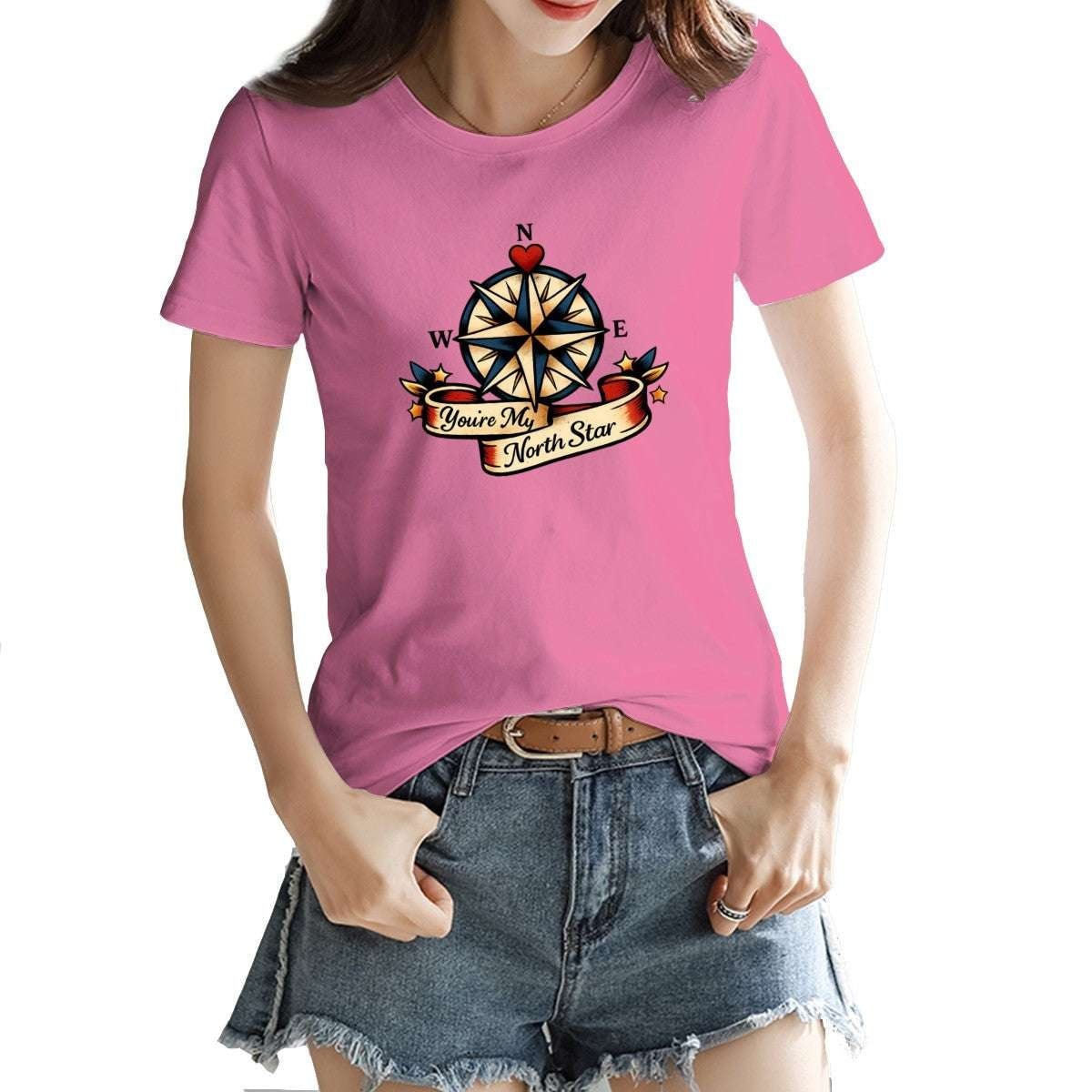 Person wearing a pink t-shirt with a compass design and text.